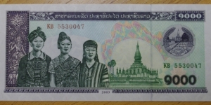Laos | 1,000 Kip, 2003 | Obverse: Three women and Pha That Luang | Reverse: Cattle grazing | Watermark: Repeated pattern of hammer, sickle and stars Banknote