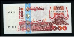1000 Dinars.

Tassili cave carvings of animals and water's buffalo head on face; hoggar cave painting of antelope and ruins on back.

Pick #142 Banknote