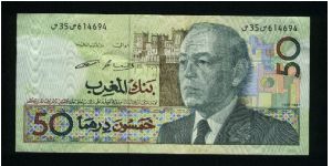 50 Dirhams.

Older bust of King Hassan II at right, fortress in background on face; mounted militia charging, flowers at center on back.

Pick #64c Banknote