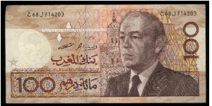 100 Dirhams.

Older bust of King Hassan II at right on face; demonstration at center on back.

Pick #65c Banknote