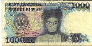 Blue-bliack on multicolour underprint. Raja Sisingamangaraja XII at center, arms at left. Yogyakarta Court at center on back. Watermark: Sultan Hasnuddin Banknote