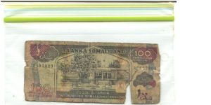 This is Somaliland

Brownish black and red-violet on multicolour underpint. Banknote