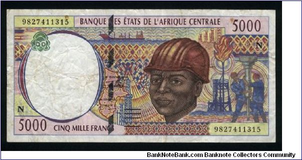 5000 Francs.

Serial -N- prefix (Equatorial Guinea).

Laborer wearing hard hat and riggers with well drill at right on face; woman with head basket at left, gathering cotton at center on back.

Pick #504N-d Banknote