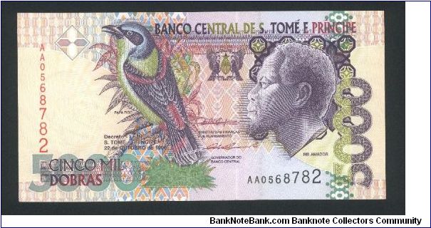 5000 Dobras.

Rei Amador at right, Papa Figo bird at left center on face; Esplanade, modern building at left center on back.

Pick #65a Banknote