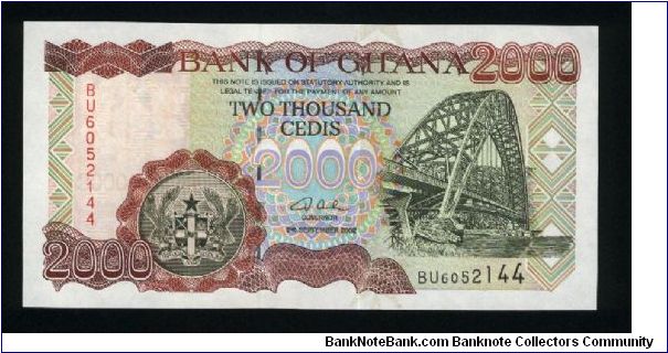 2000 Cedis.

Reduced Size Issue.

Suspension bridge at right, arms at lower left center on face; fisherman loading nets into boat at left on back.

Pick #33 Banknote