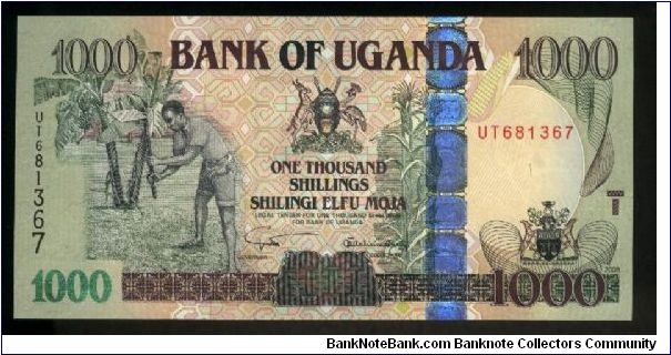 1,000 Shillings.

Farmers at left, arms at upper center and lower right, vertical OVD strip at center right on face; grain storage facility at center on back.

Pick #New Banknote