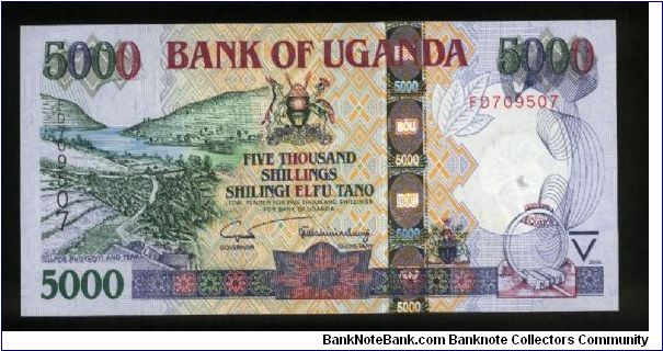 5,000 Shillings.

Lake Bunyonyi, terraces at left on face; Railroad cars being loaded onto Kaawa Ferry at center, plant at lower right on back.

Pick #NEW Banknote