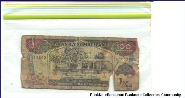 This is Somaliland

Brownish black and red-violet on multicolour underpint. Banknote