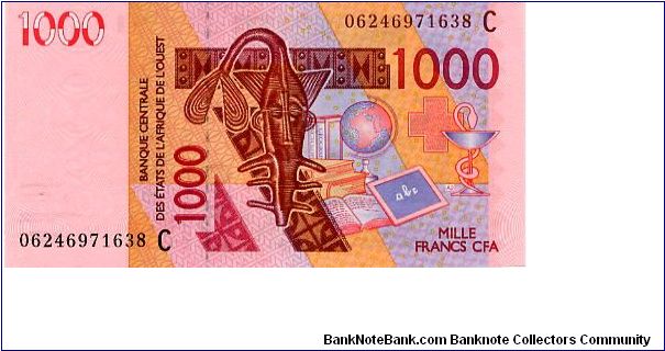 1000 Francs
Pink/Orange/Brown/Blue
Mask, globe, book & blackboard 
Camels with mountains in background 
Security thread
Wtmrk Mask Banknote