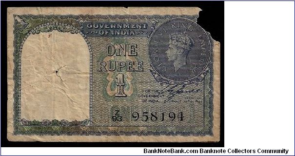 Britsh 'Government of India' 1 rupee dated 1940, # Z/93 958194. P-25a. Poor condition with the top right corner missing and a small hole in the left half. Banknote