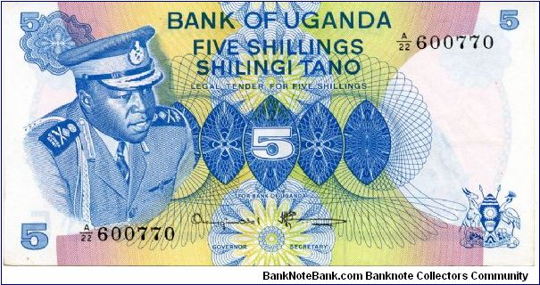 5 Shillings
Blue/Green/Pink/Brown
President Idi Amin 
Woman picking coffee 
Security thread
Watermark Bird Banknote