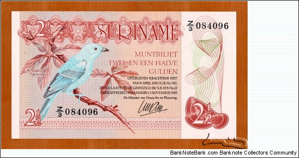 Suriname | 
2½ Gulden, 1985 | 

Obverse: A blue-grey Tanager | 
Reverse: A lizard, and A dam | Banknote