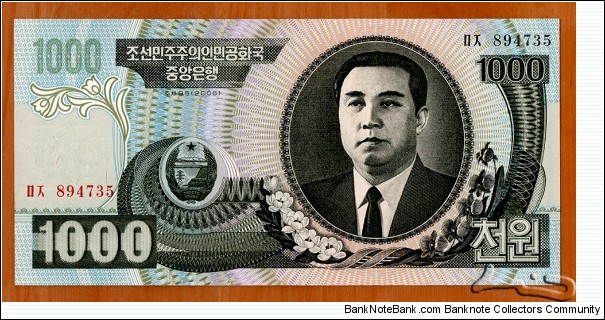 North Korea | 
1,000 Wŏn, 2006 | 

Obverse: Portrait of Kim Il-sung, and Siebold's Magnolia (Magnolia sieboldii) flowers | 
Reverse: Mangyongdae - the birthplace of Kim Il-sung | 
Watermark: Arch of Triumph in Pyongyang | Banknote